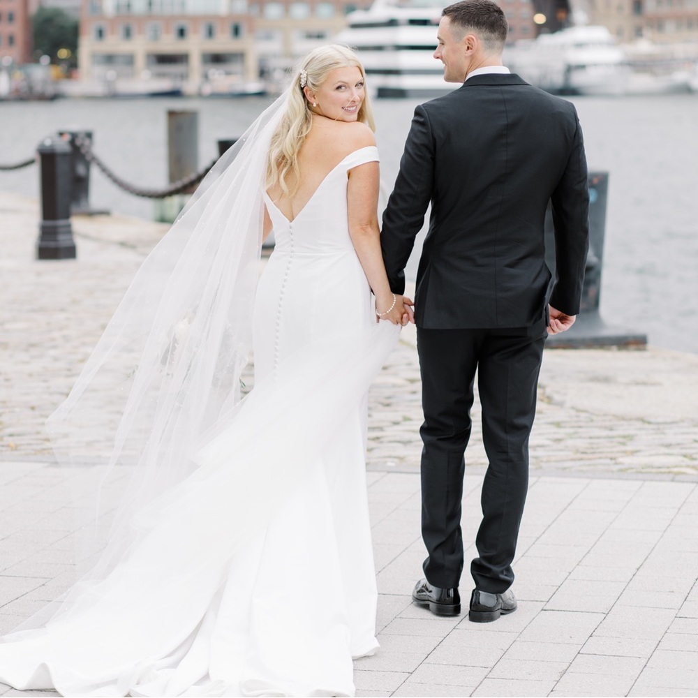 Antonio Gual designed fit and flare off the shoulder wedding dress
